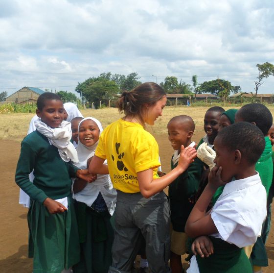 Futuresense foundation team member surrounded by children - Challenges Abroad