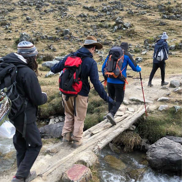 Challenges Abroad team members crossing a wooden bridge for the Machu Picchu hiking challenge