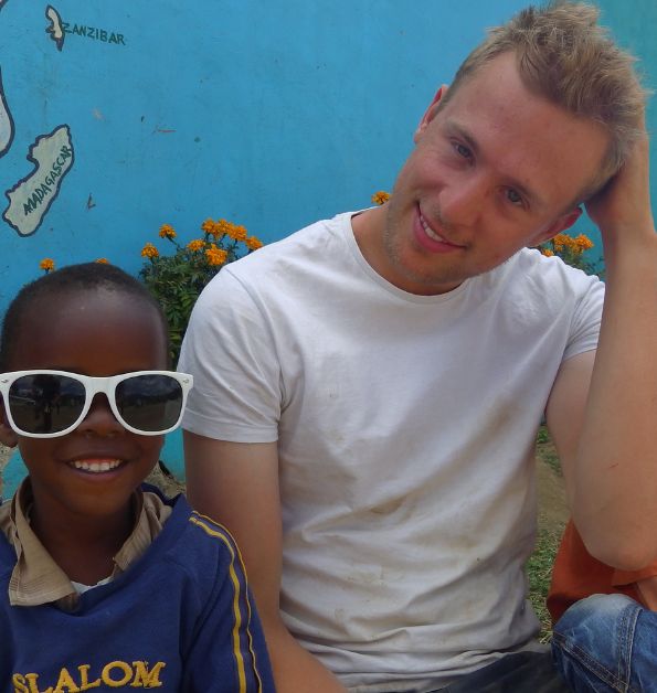 Challenges Abroad team member posing with a boy in sunglasses