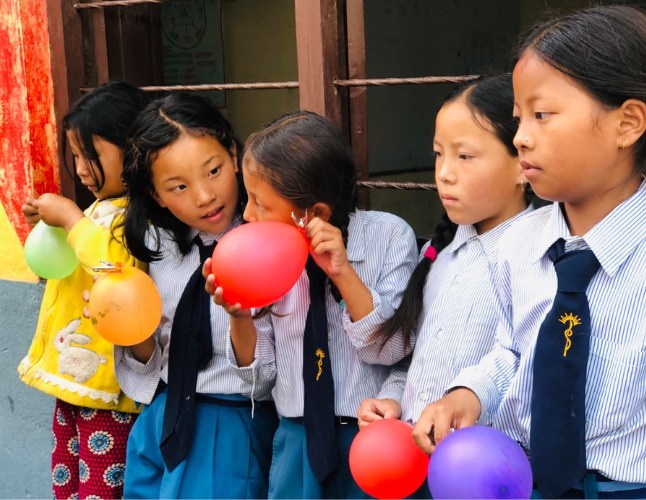 Group of children holding balloons - Challenges Abroad