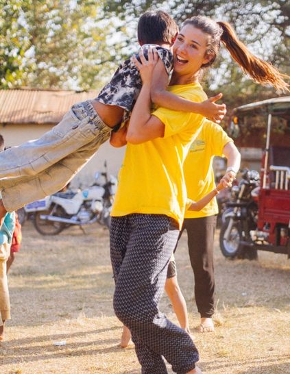 Challenges Abroad team member hugging a child in Cambodia