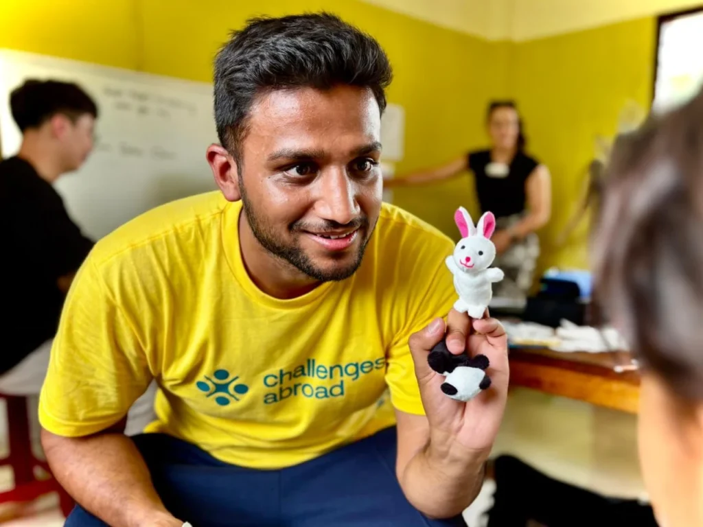 Challenges Abroad participant playfully holds hand puppet