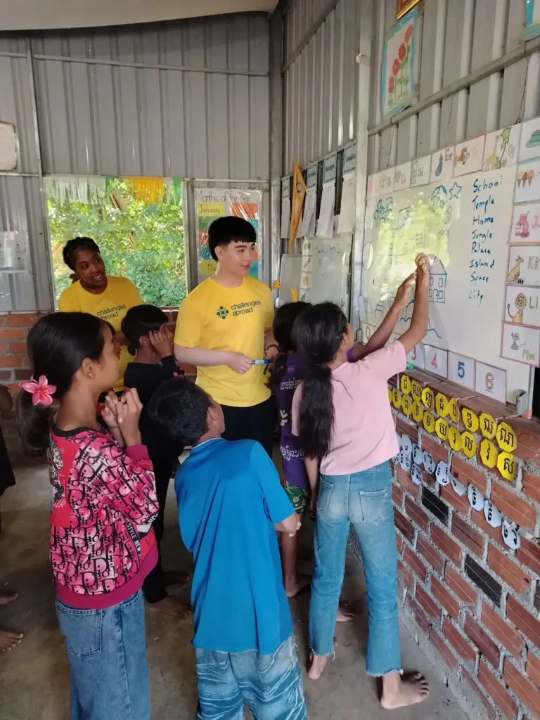 Archbishop Ilsley students leading interactive English and classroom learning activities with local children in Cambodia.