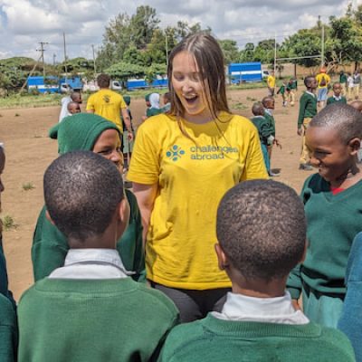 Student in Tanzania speaking to local children